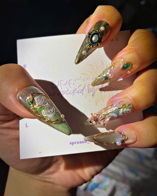 Emerald Relic press-on nails: olive cat-eye stiletto nails with cameo, emerald stones and pearls
