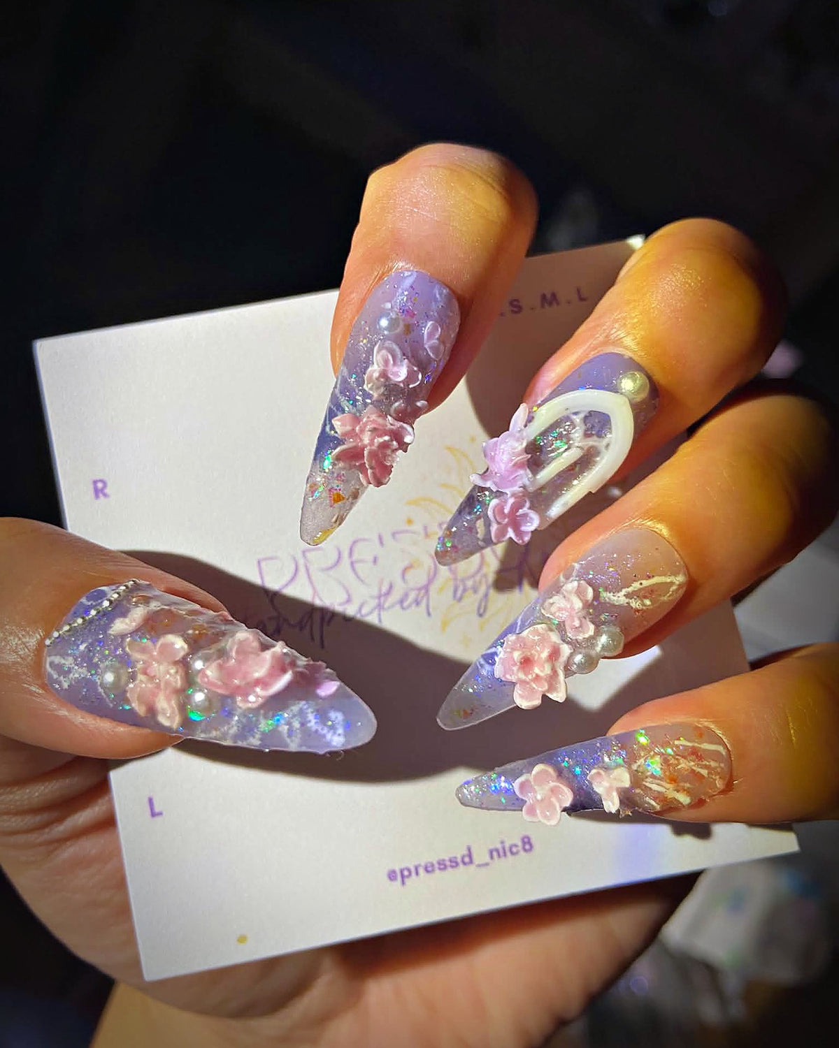 Lavender Aura press-on nails: holographic lilac stiletto nails with pink 3D flowers and pearls