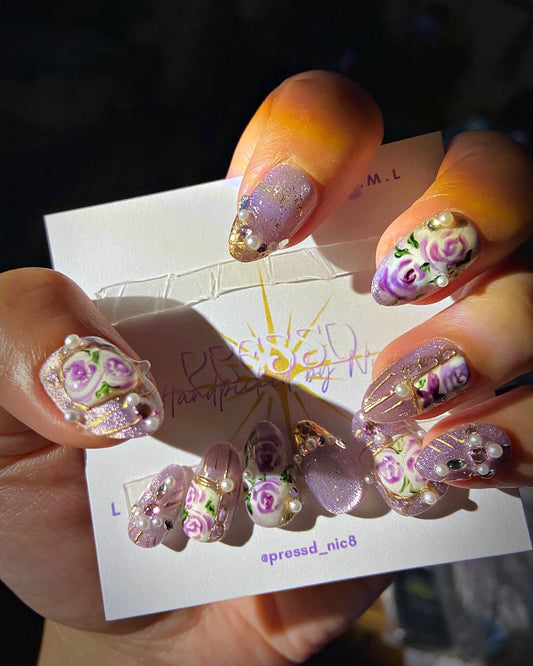 Lilac Rosette press-on nails: lilac almond nails with painted purple roses and pearls